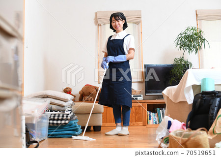Young woman cleaning the floor with a wiper Young woman cleaning the floor with a wiper 70519651