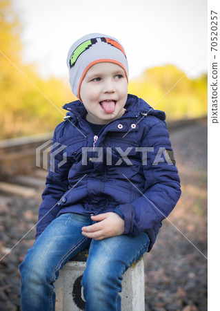 A small pre-school boy plays on the railway without supervision from adults. Railway - a zone of increased danger A small pre-school boy plays on the railway without supervision from adults. Railway - a zone of increased danger 70520257