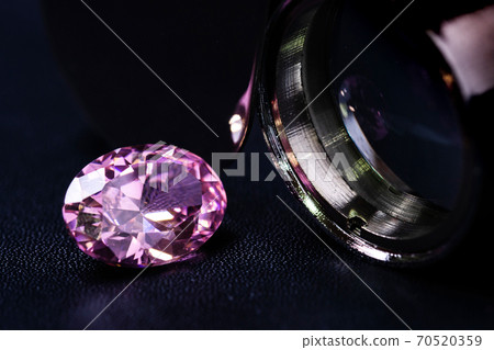 natural genuine mined pink sapphire oval cutting shape gemstone on black 70520359