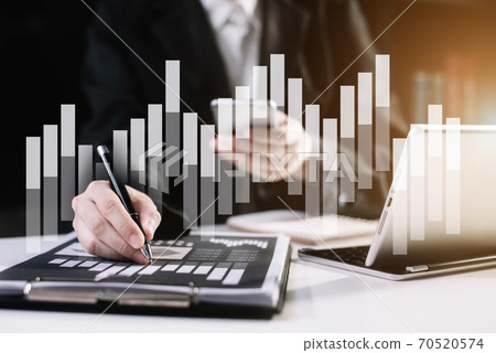 Business documents on the desk with tablet and business graph graph with office icons in the morning.  70520574