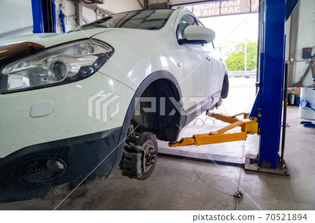 assembly of wheels on lift in workshop 70521894