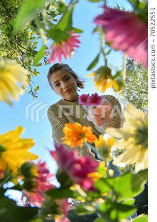 Young Girl with Bouquet Below View of Flowers Young Girl with Bouquet Below View of Flowers 70522551