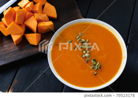 Homemade pumpkin soup on a black table Homemade pumpkin soup on a black table 70523178