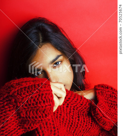 young pretty indian girl in red sweater posing emotional, fashion hipster teenage, lifestyle people concept 70525674