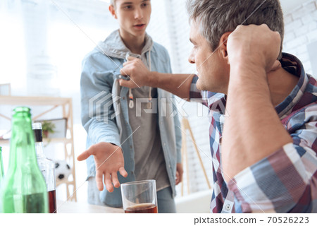 Father grabbed his son by the clothes. Father grabbed his son by the clothes. 70526223