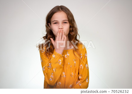 A kiss from a teen girl in white background, hand A kiss from a teen girl in white background, hand 70526232
