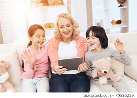 Joyful young grandmother with grandchildren. Joyful young grandmother with grandchildren. 70526239