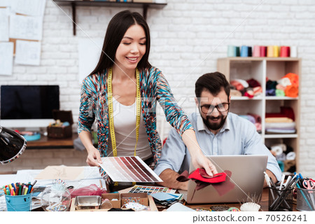 Two fashion designers looking at color swatches. 70526241