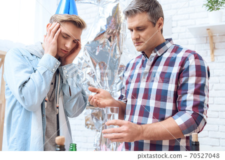 Father taking care of his son who after a party. 70527048