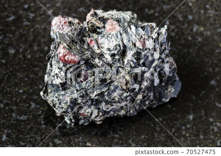 unpolished red Garnet crystals in Biotite on black unpolished red Garnet crystals in Biotite on black 70527475