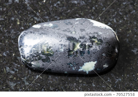 tumbled Teisky Jade (Hantigyrite) rock on black 70527558