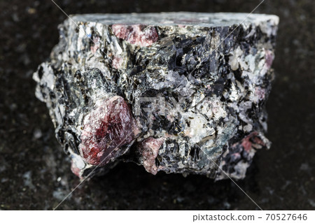 raw red Garnet crystals in Biotite rock on black 70527646