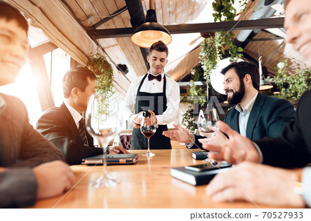 Men in a suit sitting in a restaurant. Men in a suit sitting in a restaurant. 70527933