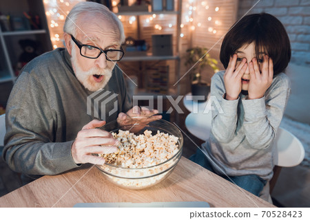 Grandson closes his eyes in fear at home. 70528423