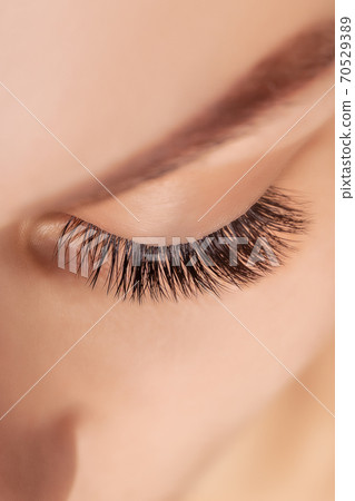 Eyelash Extension Procedure. Woman Eye with Long Eyelashes. Close up, selective focus. Eyelash Extension Procedure. Woman Eye with Long Eyelashes. Close up, selective focus. 70529389