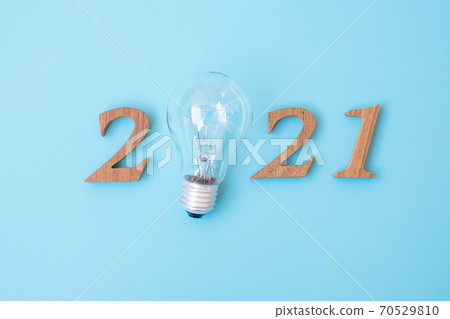 2021 Happy New year with lightbulb with and wooden number. New Start, Idea, Creative, Innovation, Resolution, Solution, Strategy, Goals and Mission concept 70529810