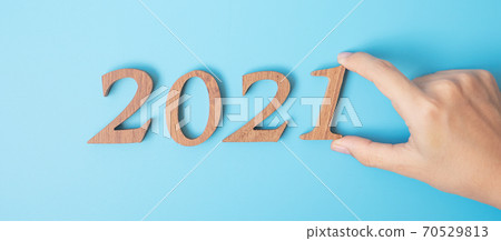 hand change 2020 to 2021 number on blue background. Resolution, strategy, solution, goal, Mission, business, New Year New You and happy holiday concepts hand change 2020 to 2021 number on blue background. Resolution, strategy, solution, goal, Mission, business, New Year New You and happy holiday concepts 70529813