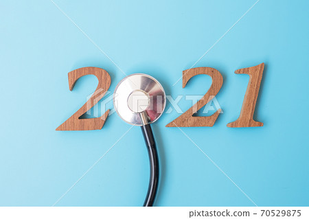 2021 Happy New Year for healthcare, Wellness and medical concept. Stethoscope and wooden number on blue background 70529875