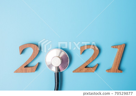 2021 Happy New Year for healthcare, Wellness and medical concept. Stethoscope and wooden number on blue background 70529877