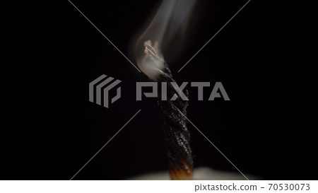Image of smouldering candle wick on black background 70530073