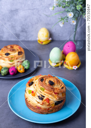 Craffin (Cruffin) with raisins, nuts and candied fruits. Easter Bread Kulich and painted eggs. Easter Holiday. Close-up. Craffin (Cruffin) with raisins, nuts and candied fruits. Easter Bread Kulich and painted eggs. Easter Holiday. Close-up. 70530847