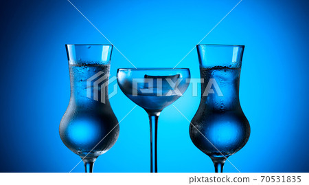 Strong alcoholic drink in frozen glasses with ice. Strong alcoholic drink in frozen glasses with ice. 70531835