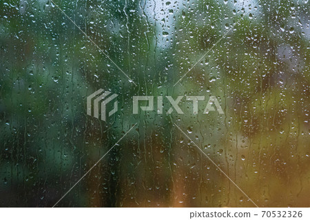 Water droplets on a window. Blurry blue and green background Water droplets on a window. Blurry blue and green background 70532326