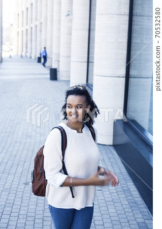 young pretty african girl posing cheerful on city background, lifestyle outdoor people concept young pretty african girl posing cheerful on city background, lifestyle outdoor people concept 70532580