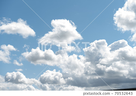 White clouds in the sky. Blue sky with puffy white summer clouds White clouds in the sky. Blue sky with puffy white summer clouds 70532643