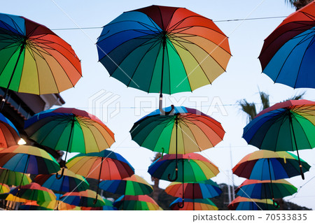 Lots of colored umbrellas hanging in the air 70533835