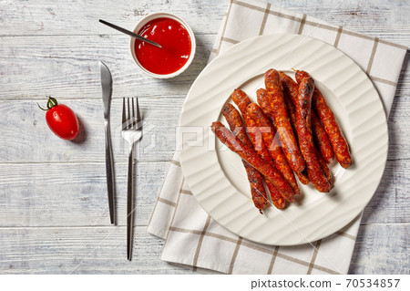 Short italian pork sausages chipolata with ketchup Short italian pork sausages chipolata with ketchup 70534857