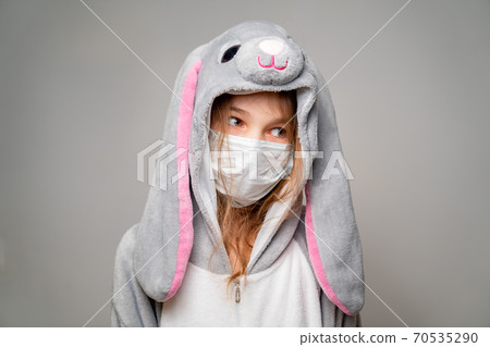 teen in kigurumi in medical mask. look away 70535290