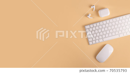 A neutral colored workplace with modern personal equipment and gadgets 70535793
