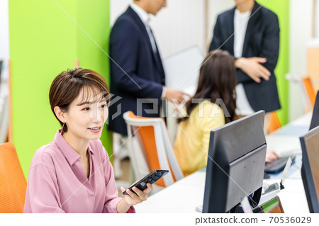 Female employee doing desk work in the office 70536029