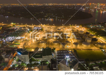 Aerial view of petrochemical oil refinery and sea in industrial engineering concept in Bangna district at night, Bangkok City, Thailand. Oil and gas tanks pipelines in industry. Modern metal factory. Aerial view of petrochemical oil refinery and sea in industrial engineering concept in Bangna district at night, Bangkok City, Thailand. Oil and gas tanks pipelines in industry. Modern metal factory. 70536105
