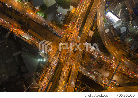 Aerial view of cars driving on highway junctions. Bridge street roads in connection network of architecture concept. Top view. Urban city, Bangkok at night, Thailand. Aerial view of cars driving on highway junctions. Bridge street roads in connection network of architecture concept. Top view. Urban city, Bangkok at night, Thailand. 70536109