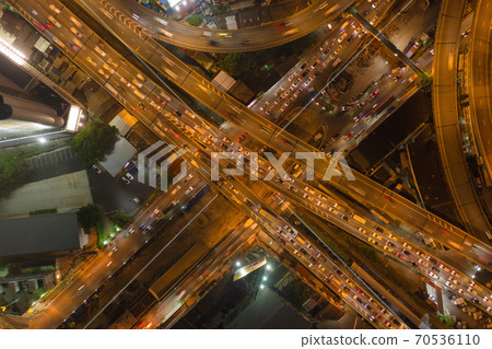 Aerial view of cars driving on highway junctions. Bridge street roads in connection network of architecture concept. Top view. Urban city, Bangkok at night, Thailand. Aerial view of cars driving on highway junctions. Bridge street roads in connection network of architecture concept. Top view. Urban city, Bangkok at night, Thailand. 70536110