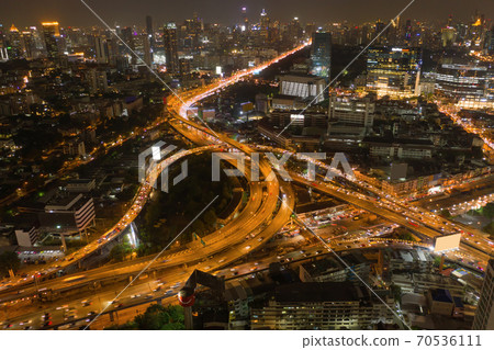 Aerial view of cars driving on highway junctions. Bridge street roads in connection network of architecture concept. Top view. Urban city, Bangkok at night, Thailand. Aerial view of cars driving on highway junctions. Bridge street roads in connection network of architecture concept. Top view. Urban city, Bangkok at night, Thailand. 70536111