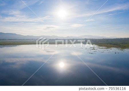 Aerial view of Bang Pra Reservoir dam. National park with reflection of river lake, mountain valley hills at noon and blue sky in Sri Racha, Chonburi, Thailand in travel trip. Natural landscape. 70536116