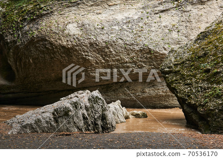 mountain gorge with muddy river during flooding mountain gorge with muddy river during flooding 70536170