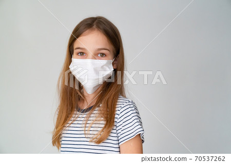 a teenager girl in medical mask white background 70537262