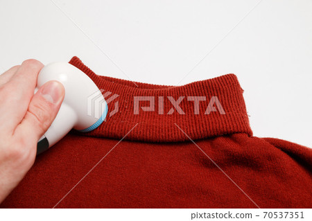 Device for removing lint from wool clothes. Golf with fuzz ball isolated on white background. Device for removing lint from wool clothes. Golf with fuzz ball isolated on white background. 70537351
