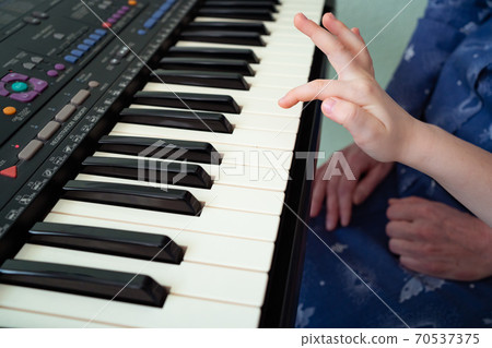 little hands black white piano keys synth close-up little hands black white piano keys synth close-up 70537375