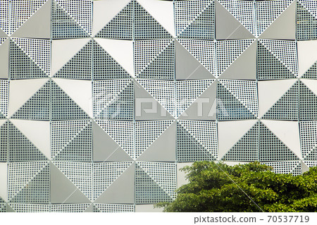 A modern facade on a building in the streets of Saigon. A modern facade on a building in the streets of Saigon. 70537719