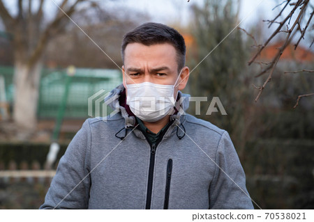 man in jacket in medical  mask on street 70538021