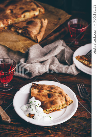 Slice of cabbage pie with sour cream sauce Slice of cabbage pie with sour cream sauce 70538115
