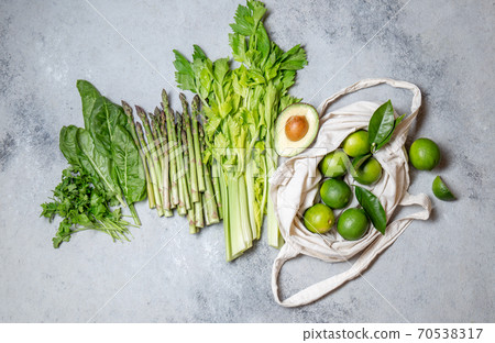 Healthy food ingredients gree vegetables and fruits on gray background Healthy food ingredients gree vegetables and fruits on gray background 70538317