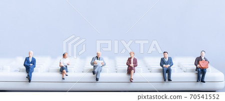 Elderly people sitting on coins stack.  70541552