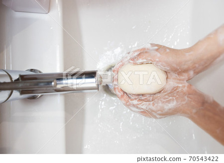 thorough washing of female hands  soap and water 70543422