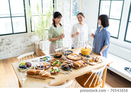 A woman enjoying a meal and chatting 70543856